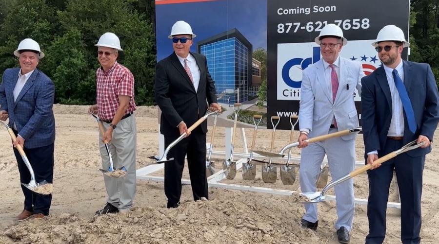people holding shovels at groundbreaking event