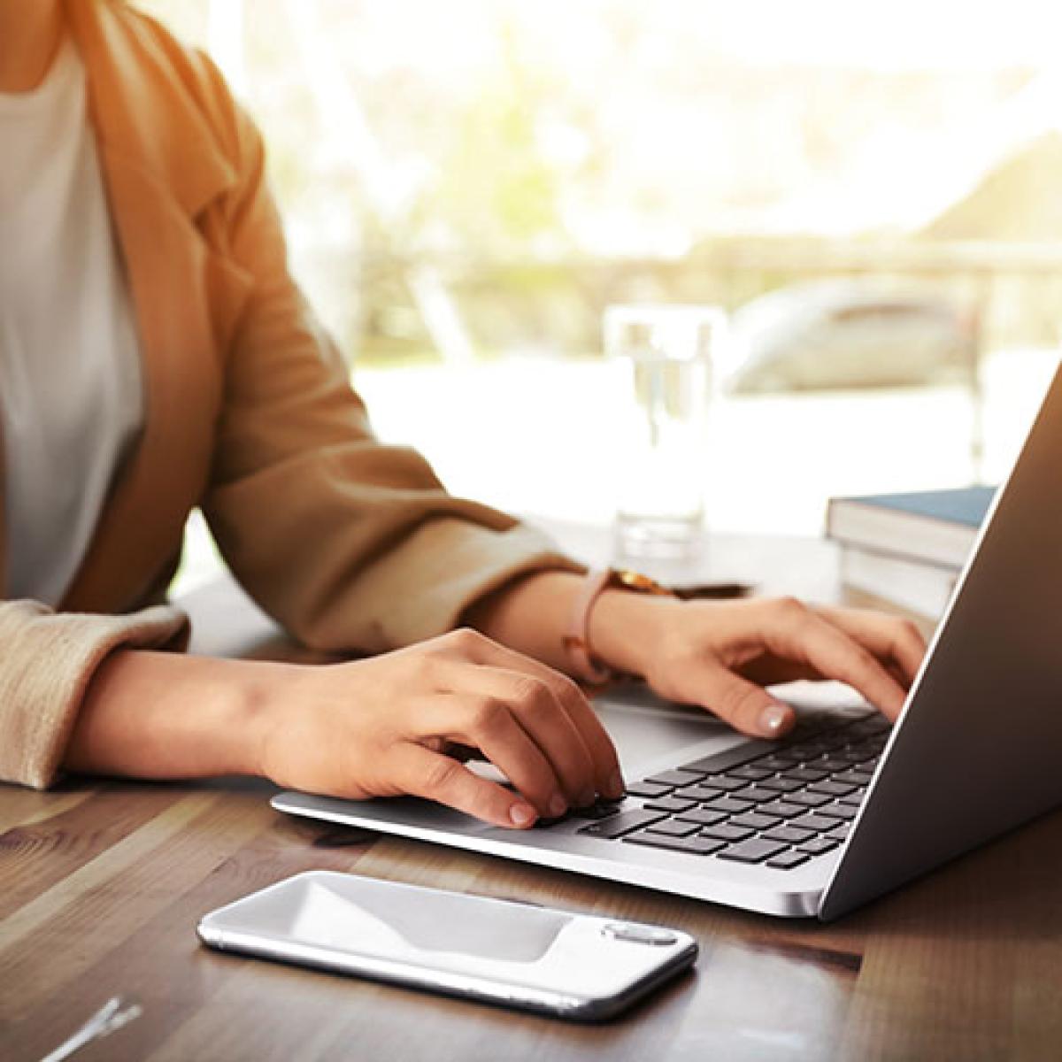 A person typing on their laptop.