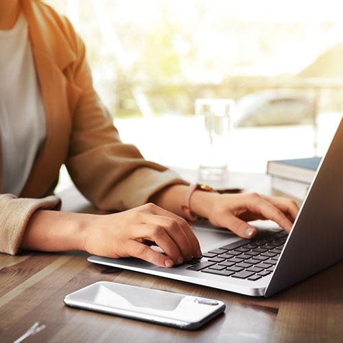 A person typing on their laptop.