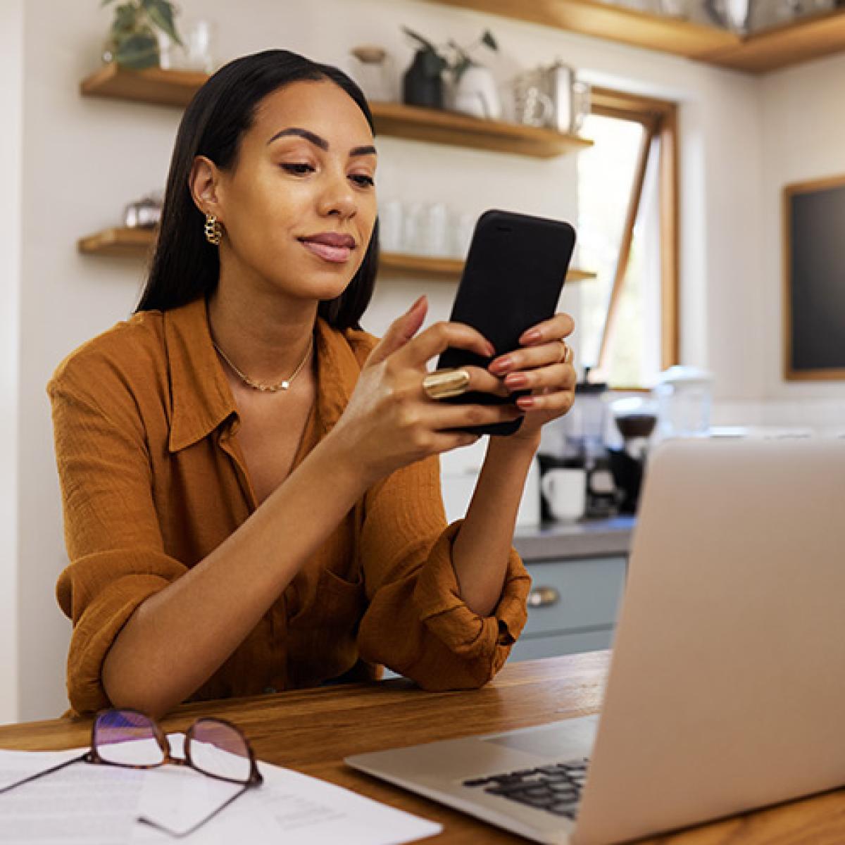 A woman looks at her phone.