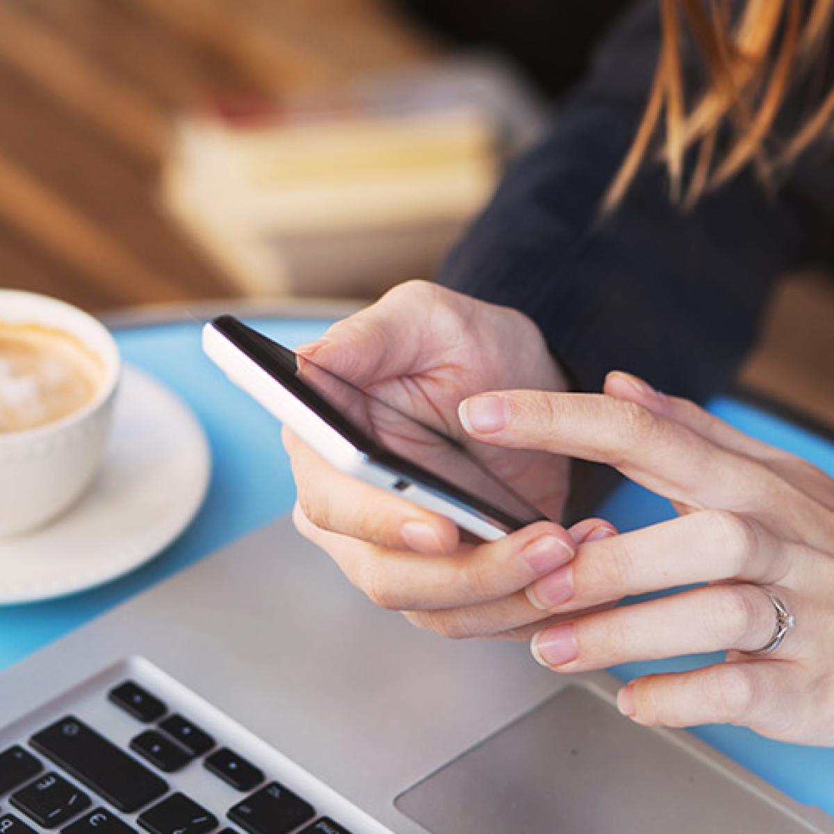 A woman's hand holding a phone.