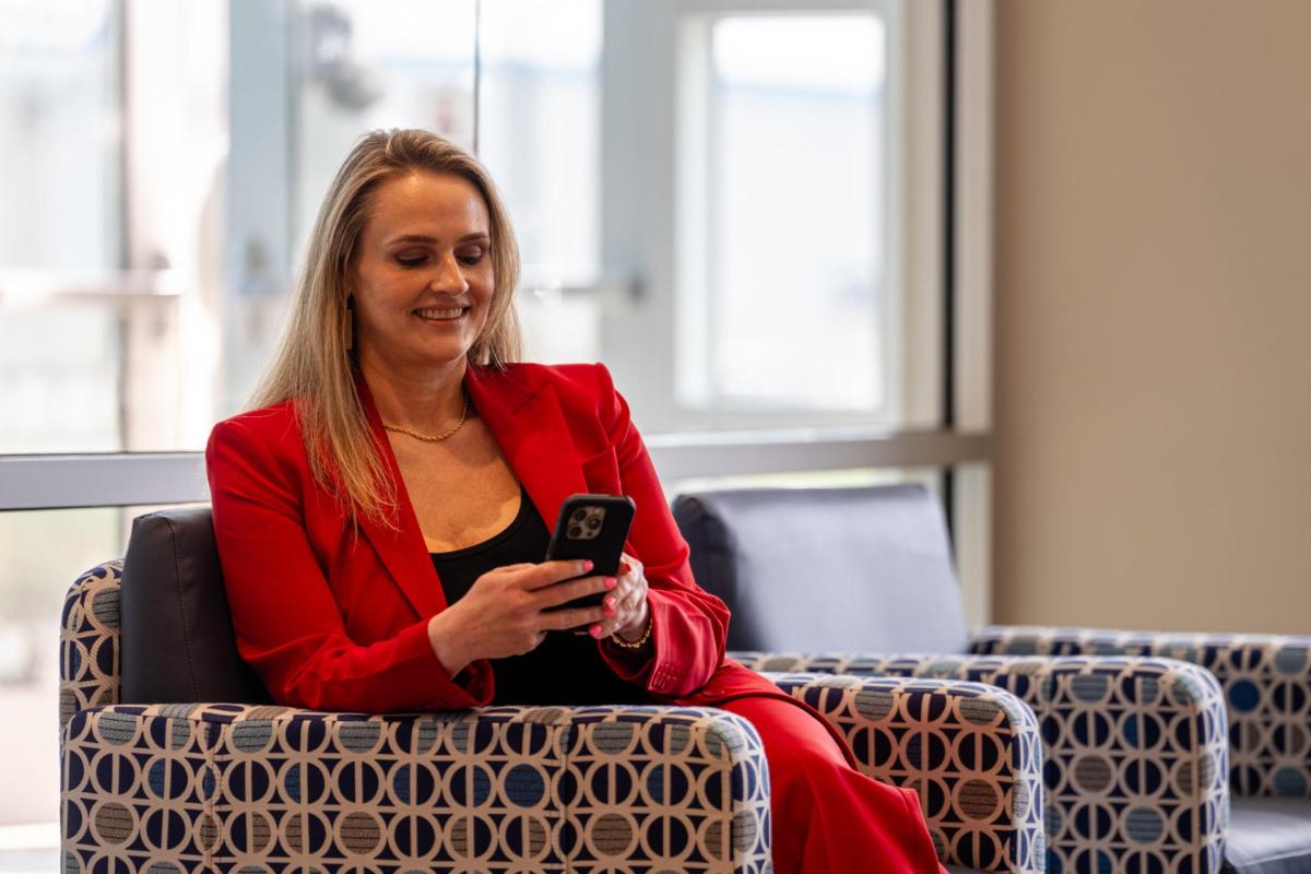 A woman looks at her phone.