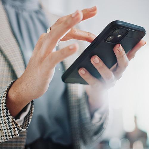 A close-up of hands holding a phone.