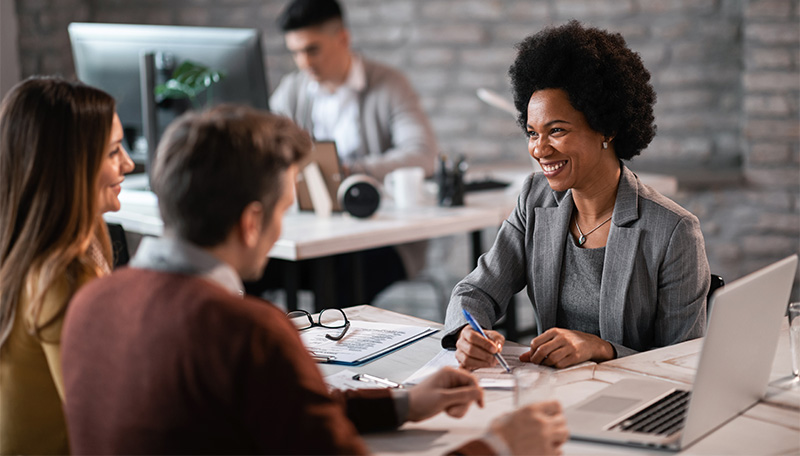 couple working with smiling banker